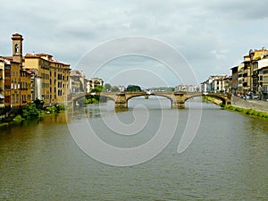 Scenic view of the graceful Santa Trinita Bridge on a cloudy rainy summer day