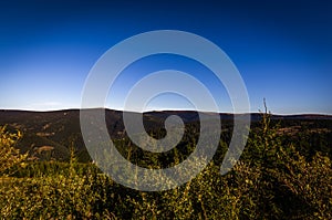 Scenic view with green forest and dark blue sky from top Dlouhe strane reservoir to mountain Praded