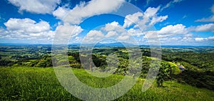 Scenic view of green hills against the backdrop of the blue sky. Tablelands, Australia.