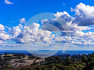 Scenic view with green hills and blue sky with white fluffy clouds 2.