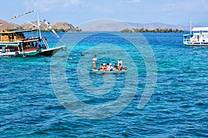 Scenic view of a group of tourists riding a conoe heading to the mainland