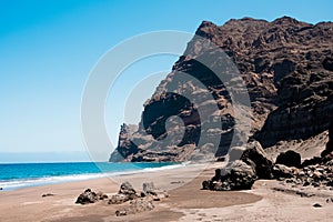 Scenic view of gui gui beach in gran canaria island in spain with spectacular mountains landscape and clear blue sky and sandy