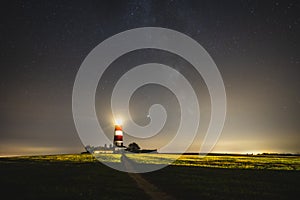 Scenic view of the Happisburgh Lighthouse illuminating at night, Great Britain