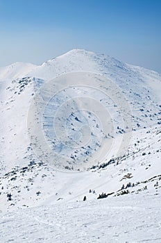 Scenic view of the hill from the top of the mountain and country ski tracks.