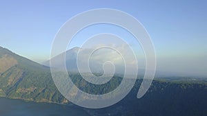 Scenic view of hills and mountains with clouds sky and lake on summer day.