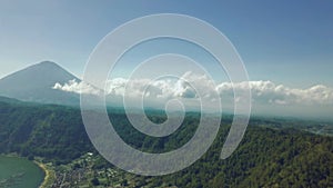 Scenic view of hills and mountains with clouds sky and lake on summer day.