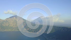 Scenic view of hills and mountains with clouds sky and lake on summer day.