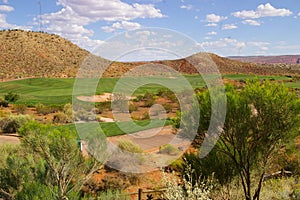 Scenic view from hilltop of golf course, mountains, and clear blue sky in Utah