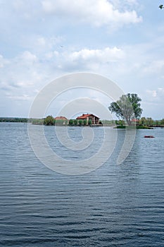 Scenic view of the house, lake, bridge in the distance, vertical fish farming