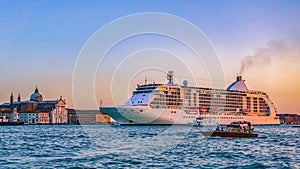 Scenic view of a huge ship in the Grand Canal in Venice, Italy, during a colorful sunset