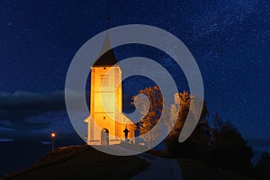 Scenic view of illuminated Jamnik church St Primus and Felician on the hill at night, Slovenia