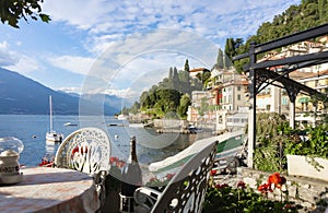 Scenic view of the Italian resort town of Varenna on the shores of the mountain lake Garda in the Alps. A cozy restaurant, old