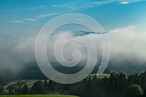 Petzen - Scenic view of Jauntal valley covered by thick clouds seen from mountain resort Petzen, Bleiburg, Carinthia photo