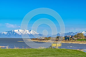 Scenic view of a lake with houses near the shore and mountain in the distance