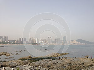 Scenic view of a large city situated on a rocky shoreline