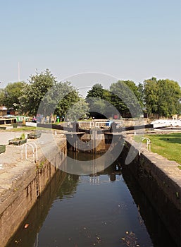 A scenic view of lock gate entrance to brighouse basin with boats and moorings on the calder and hebble navigation canal in west