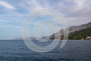 Scenic view of Makarska Riviera with untamed mountain range Biokovo Dinaric Alps. Majestic coastline of Adriatic Mediterranean Sea