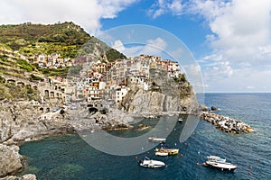 Scenic view of Manarola village, one of the five villages along Cinque Terre hiking trail in Italy, popular as tourist