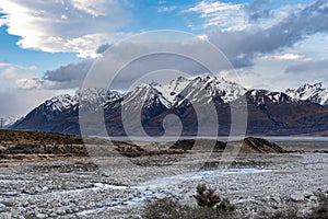 Scenic view at Mount Cook Road alongside Lake Pukaki with snow capped Southern Alps