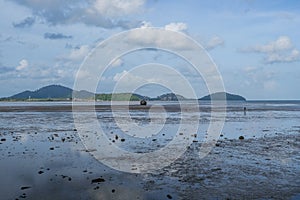 Scenic View Of Mud Beach Against Broken Ship Cloudy Sky.