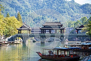 Scenic view of the old houses reflected in water of the Tuojiang River Tuo Jiang River in Phoenix Ancient Town