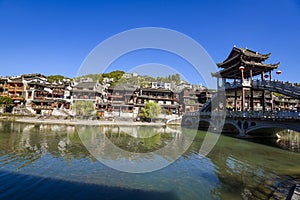 Scenic view of the old houses reflected in water of the Tuojiang River Tuo Jiang River in Phoenix Ancient Town