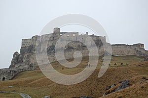 Scenic view of old stone european castle with grey fog on background