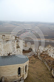 Scenic view of old stone european castle with grey fog on background