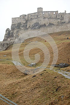 Scenic view of old stone european castle with grey fog on background