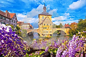 Scenic view of Old Town Hall of Bamberg Altes Rathaus with two bridges over the Regnitz river flower view