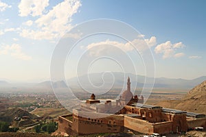 Scenic view onto the Ishak Pasha Palace, Sarayi with the town of Dogubeyazit and the surrounding lanscape in the background,