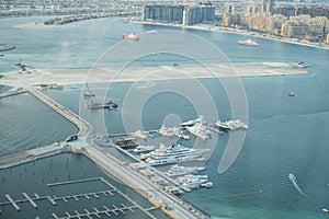Scenic view over Dubai Marina harbor with boats and yachts.
