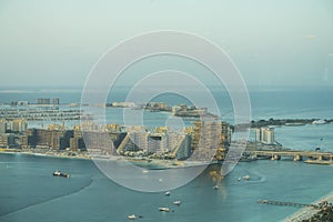 Scenic view over Dubai Marina harbor with boats and yachts.