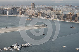 Scenic view over Dubai Marina harbor with boats and yachts.