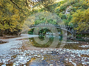 Scenic view over the natural beauty at the famous voidomatis river passing from the National park of Vikos and a beautiful bridge