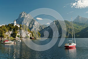 Scenic view on the perched Johannesberg Chapel in Austria, surrounded by mountains and the lake Traunsee