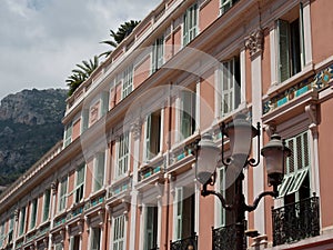 Scenic view of a pink old building with white windows in Monte Carlo, Monaco