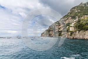 Scenic view of Positano cliff and sea with boats along Amalfi Coast in Campania, Italy
