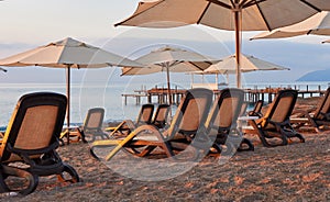 Scenic view of private sandy beach on the beach with sun beds against the sea and mountains. Amara Dolce Vita Luxury