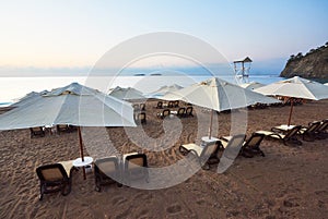 Scenic view of private sandy beach on the beach with sun beds against the sea and mountains. Amara Dolce Vita Luxury