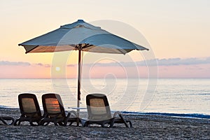 Scenic view of private sandy beach on the beach with sun beds against the sea and mountains. Amara Dolce Vita Luxury