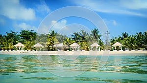 Scenic view of private sandy beach with sun beds from the sea