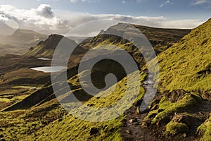 Scenic view of Quiraing mountains in Isle of Skye, Scottish highlands, United Kingdom. Sunrise time with colourful an rayini