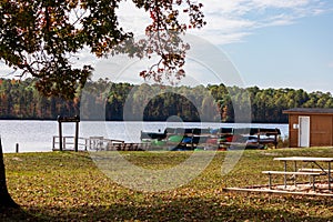 Scenic view of rental boats at a lake against trees at Cheraw State Park in Chesterfield County