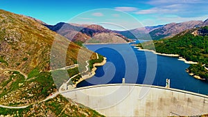 A scenic view of reservoirs and hydroelectric stations nestled in mountains