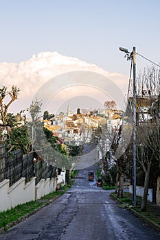 Scenic View of a Residential Street in a Charming Hilly Town with a Mosque in the Distance