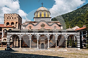 Scenic view of the Rila Monastery against a cloudy blue sky in Bulgaria
