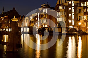 Scenic view of the river and city buildings illuminated at night. Leiden, the Netherlands