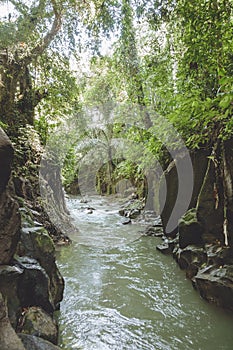 scenic view of river, rocky formations and green plants near Kanto Lampo Waterfall,