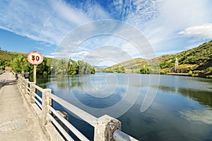 Scenic view of a road and lake in a mountain scenary.